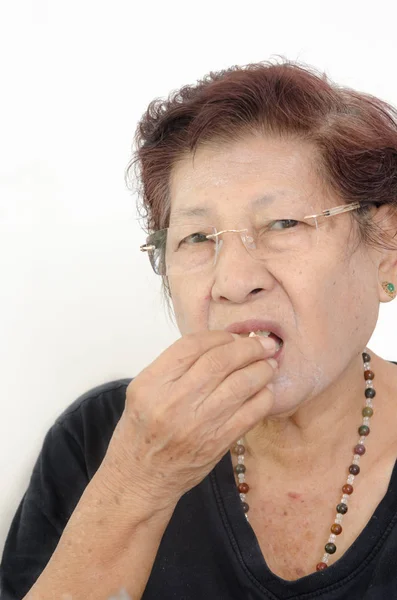 Asian senior woman eating popcorn while watching TV, at home. — Stock Photo, Image