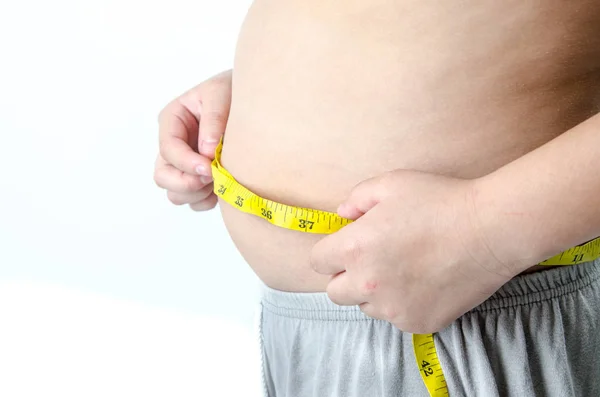 The boy with his belly with a tape measure on a white background — Stock Photo, Image