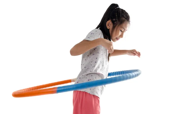 Happy girl playing hula hoop on white background — Stock Photo, Image