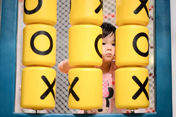 Cute Asian girl playing in playground indoor. — Stock Photo, Image