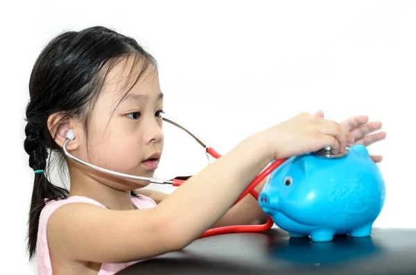 Girl doctor cure with piggy bank, money concept. — Stock Photo, Image