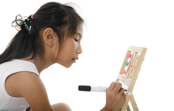 Menina escrevendo no quadro branco isolado no branco . — Fotografia de Stock