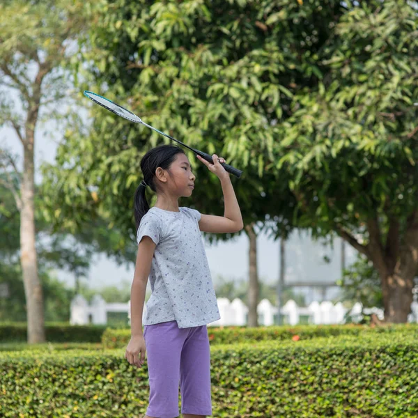 Asian girl playing badminton outdoor. — Stock Photo, Image