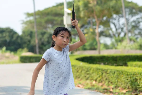 Asian girl playing badminton outdoor. — Stock Photo, Image