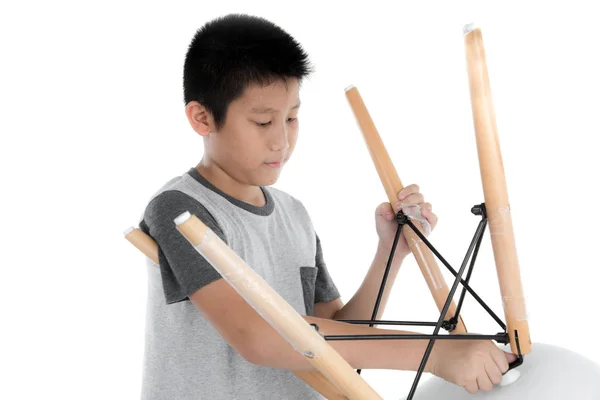 Asian boy repair leg chair on white backgorund. — Stock Photo, Image