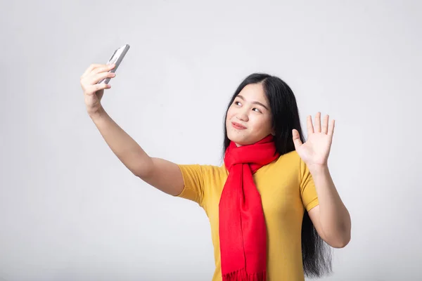 Asian woman wearing red scarf making video call to family. — Stock Photo, Image