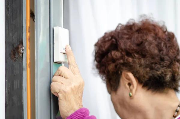 Asiatische Seniorin klingelt an Tür, Lifestylekonzept. — Stockfoto