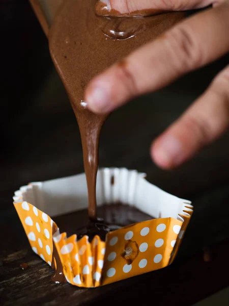 Rozmycie ruchu przetwarzania domowych babeczek czekoladowych na stole. — Zdjęcie stockowe