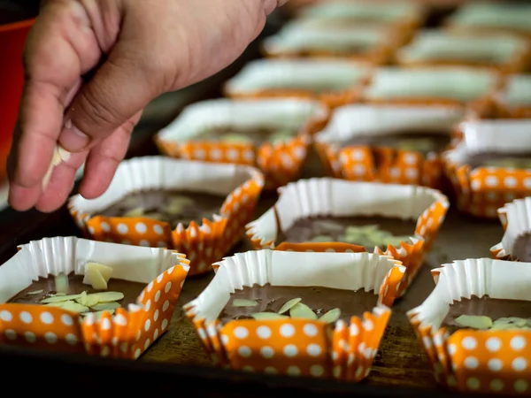 Motion blur spreading almonds sliced on homemade chocolate cupca — Stock Photo, Image