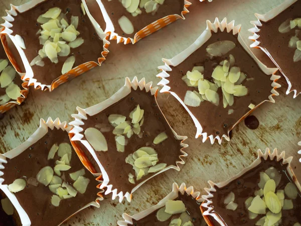 Motion blur spreading almonds sliced on homemade chocolate cupca — Stock Photo, Image