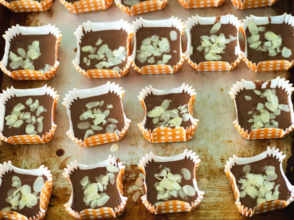 Motion blur spreading almonds sliced on homemade chocolate cupca — Stock Photo, Image