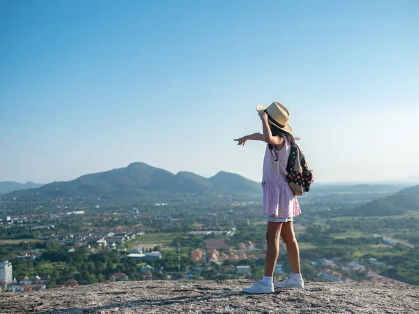 Girl with backpack pointing  on the top of city view, lifestyle — Stock Fotó