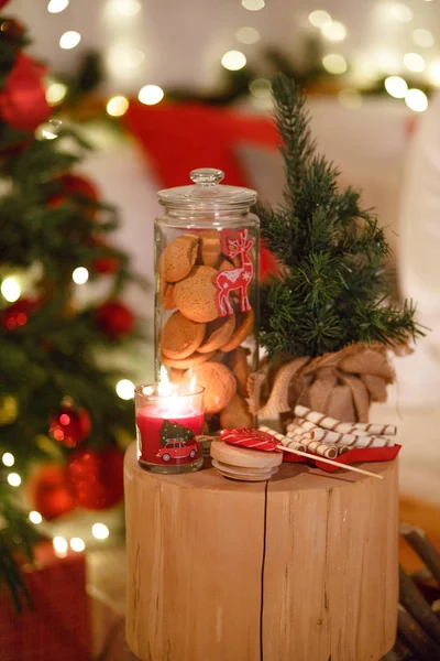 圣诞饼干在玻璃瓶里 圣诞装饰中的节庆糖果 靠近圣诞树 上面点缀着花环 — 图库照片