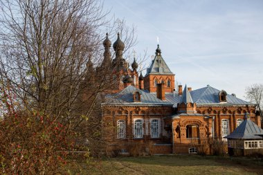 Kaluga Bakiresi 'nin manastırı. Güneşin parlak ışığında. Shamordino 'daki manastırın yüksek duvarlarını kırmızı tuğla oymuş.