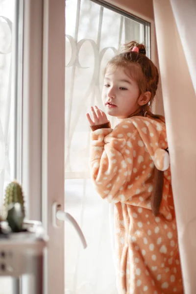 Little Girl Plush Pajamas Hood Plays Window Curtain Girl Walks — Stock Photo, Image
