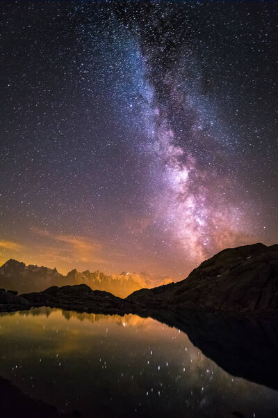 Milky Way and Starry Sky over Iconic Snowy Mont-Blanc Peaks Reflecting in Altitude Lake