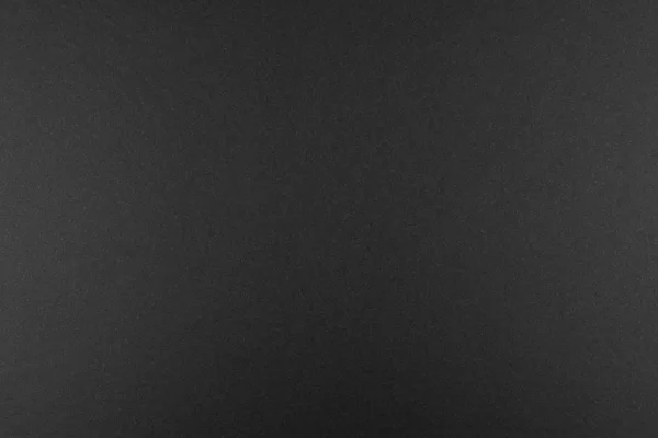 Yukardan gelen yumuşak bir ışıkla aydınlatılan fibröz yapıya sahip gerçek siyah kağıttan yapılmış siyah arkaplan..