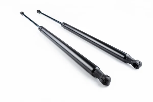 İki yeni gaz yayları, şok emiciler, kesme yolu olan beyaz arka planda izole edilmiş..