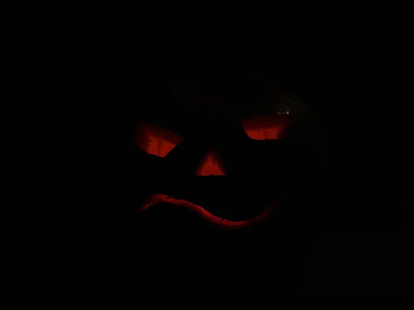 Scary Halloween pumpkins isolated on a black background.  glowing faces trick or treat — Stock Photo, Image