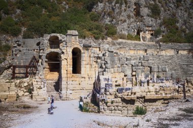  The ancient Greco-Roman theater in Lycian city.Tourists visitin clipart