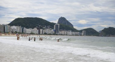 Rio de Janeiro, Brasil- 26 Şubat 2020: vatandaşlar Copacabana sahilinde yüzer ve güneşlenirler.