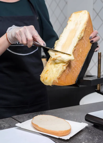 Scraping Melted Traditional Swiss Raclette Cheese — Stock Photo, Image