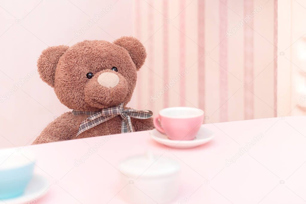 A plush teddy bear at a tea party