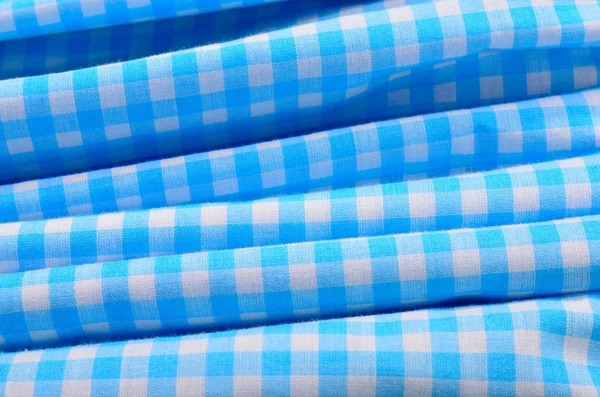 Classic linen blue and white checked tablecloth on folded fabric