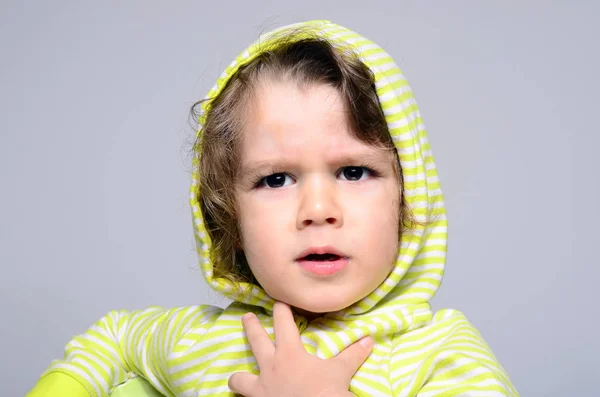 Portrait of an angry toddler with a hoodie. beautiful boy arguing with his parents — Stock Photo, Image