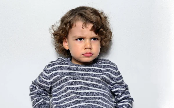 Beautiful angry boy looking at you. Mad kid got upset and sad and he has a negative attitude. Depressed boy  complaining — Stock Photo, Image