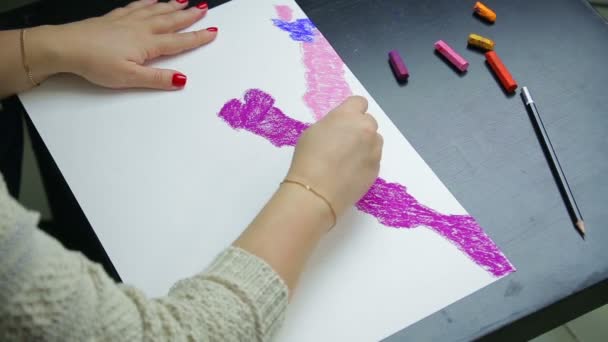 La mano femenina dibuja sobre papel blanco con cielo pastel púrpura al atardecer — Vídeos de Stock