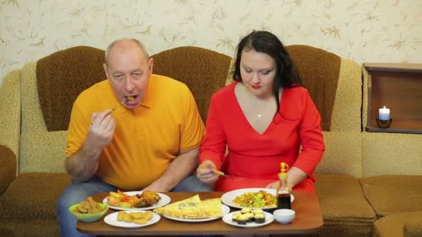 Muž a žena jsou na večeři v místnosti se smaženým kuřetem a zeleninou. — Stock video
