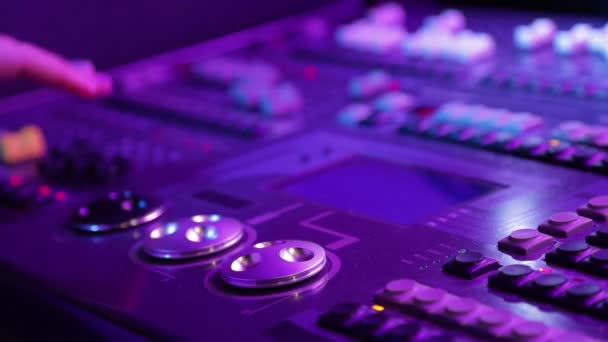 A female hand works behind a mixing light control console — Stock Video