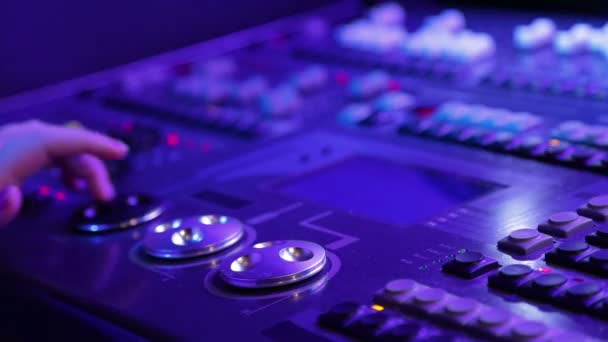 A female hand works behind a mixing light control console — Stock Video