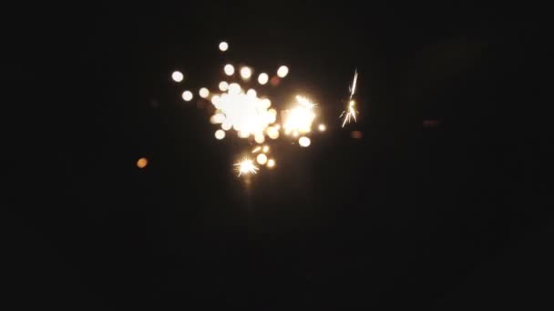 Golden color firework generator for rooms on a black background — Stock Video
