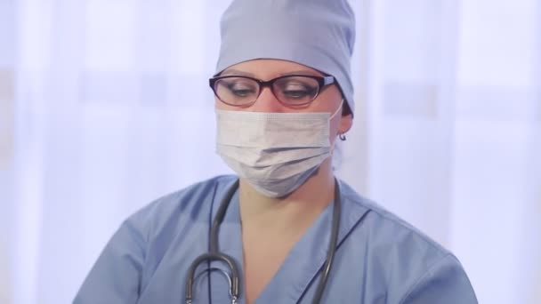 A female doctor examines images of a magnetic resonance imaging of the brain. — Stock Video