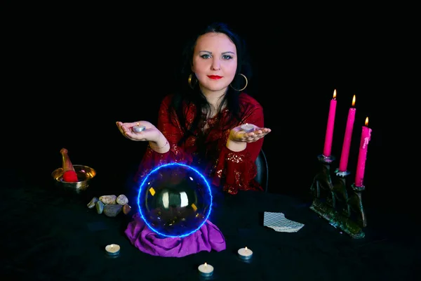 A young Jewish clairvoyant works about candles on the palms. — Stock Photo, Image