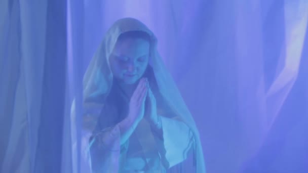 Uma jovem noiva judia de branco faz uma oração antes do casamento atrás de uma cortina branca . — Vídeo de Stock