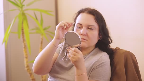 Γυναίκα μάσκαρα μάτια στο σπίτι μπροστά από έναν καθρέφτη — Αρχείο Βίντεο