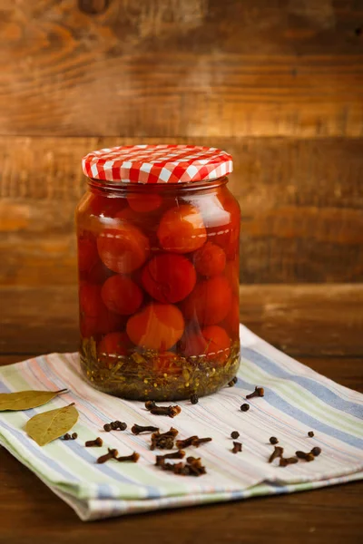 Frascos de tomates cherry en escabeche caseros en escabeche sobre una mesa de madera . —  Fotos de Stock