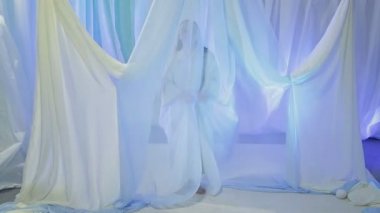 Young Jewish bride rehearsing an exit under the chuppah before the wedding.
