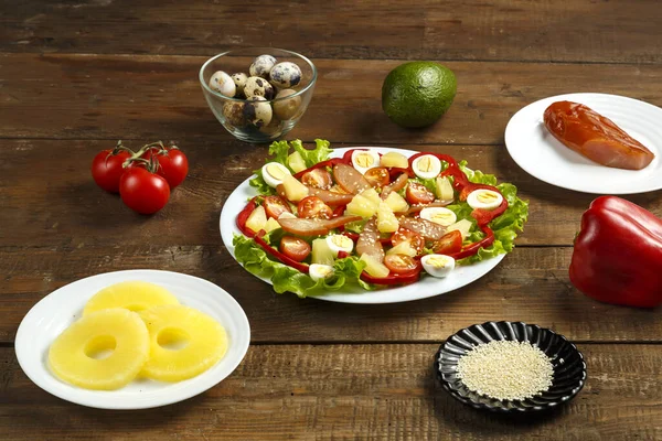 Pan-Asian salad with cherry tomatoes, smoked chicken, pineapple and sesame seeds and a range of ingredients.