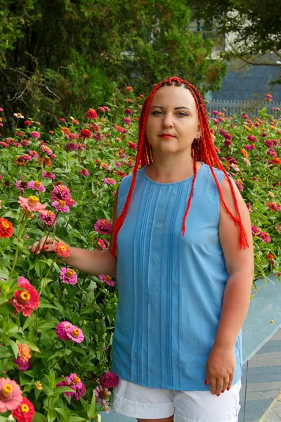 Young woman with red hair posing in red orange colors. — 图库照片