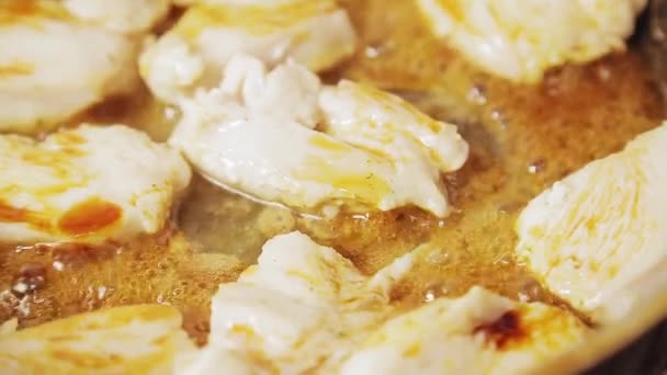 Chicken fillet is fried in boiling oil in a pan. — Stock Video