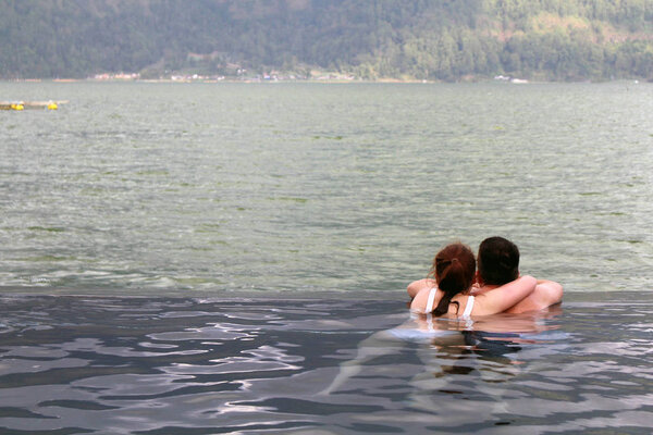 People are enjoying dipping in a hotspring (Toya Devasya), by th