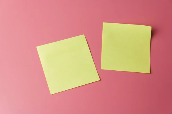 Two yellow sticky note reminders on a red background