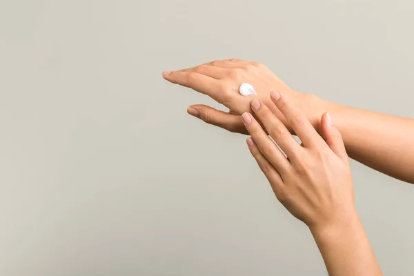 Closeup view of woman hands applying hand cream. beauty shot — 스톡 사진