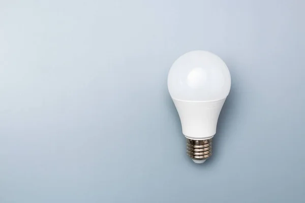 white led bulb on grey background with copy space for advert. business idea concept.