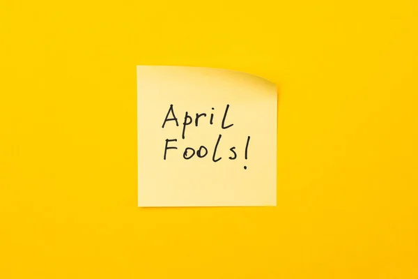 april fools day reminder on yellow sticky note. be aware and do not let be fooled.