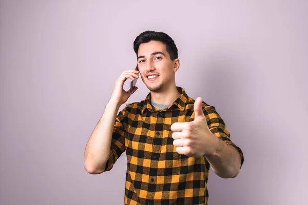 Handsome Brunette Young Man Speaking Phone Showing Big Thumb Purple — Stock Photo, Image